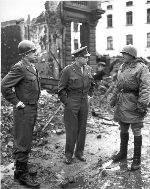 general_omar_bradley_general_dwight_eisenhower_and_general_george_patton_all_graduates_of_west_point_survey_war_damage_in_bastogne_belgium-_1944-1945
