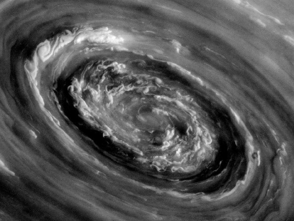 Storm clouds and a swirling vortex at the center of Saturn’s north ...