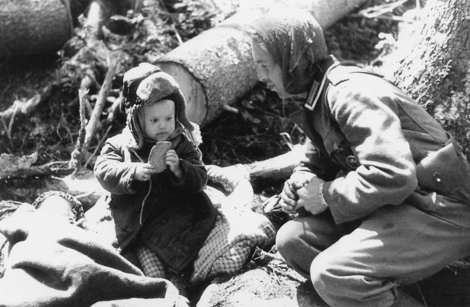 german-soldier-giving-bread-to-an-orphaned-russian-boy-volkhov-area-1942