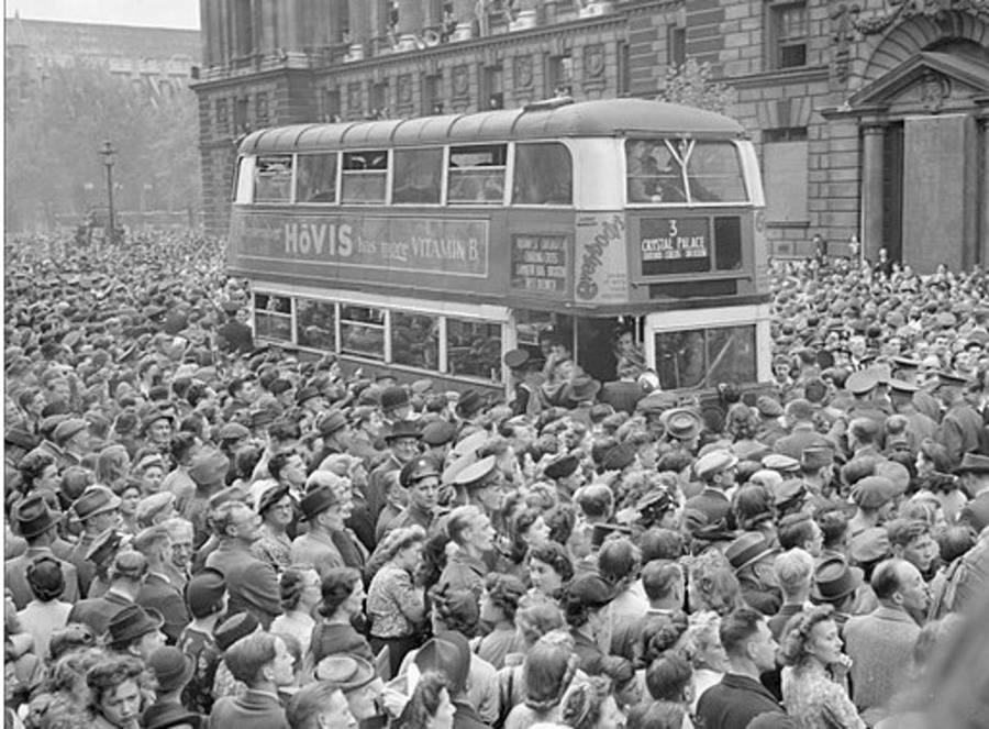 crowds-of-people-surround-a-bus